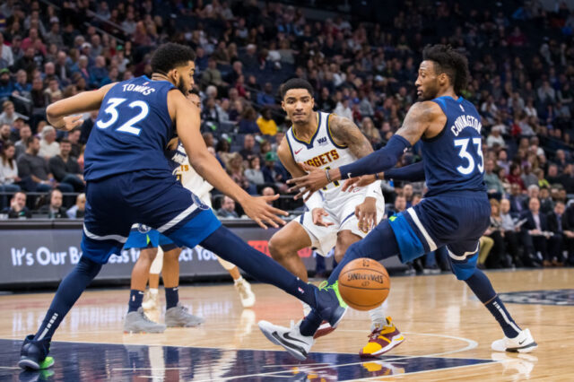 Denver Nuggets guard Gary Harris (14) passes in the second quarter against Minnesota Timberwolves center Karl-Anthony Towns (32) and forward Robert Covington (33) at Target Center.