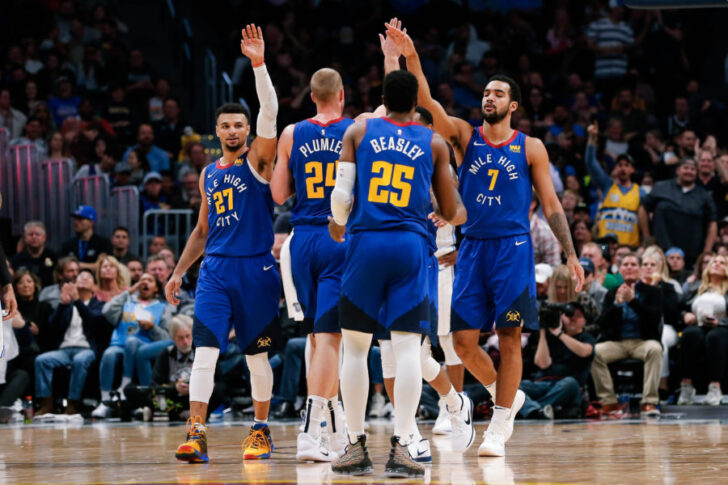 Denver Nuggets guard Jamal Murray (27) and forward Mason Plumlee (24) and guard Malik Beasley (25) and forward Trey Lyles (7) celebrate after a play in the fourth quarter against the Orlando Magic at the Pepsi Center.