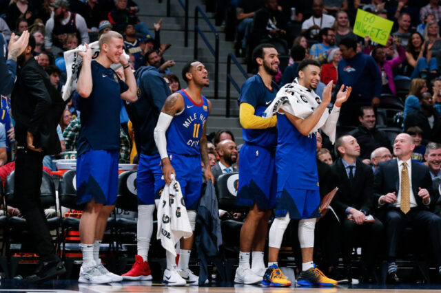 Denver Nuggets forward Mason Plumlee (24) and guard Monte Morris (11) and forward Trey Lyles (7) and guard Jamal Murray (27) react from the bench after a play in the fourth quarter against the Orlando Magic at the Pepsi Center.