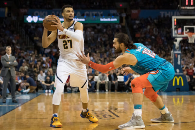 Denver Nuggets guard Jamal Murray (27) looks to pass the ball while defended by Oklahoma City Thunder center Steven Adams (12) during the second quarter at Chesapeake Energy Arena.
