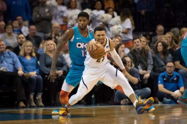 Denver Nuggets guard Jamal Murray (27) fouled by Oklahoma City Thunder forward Paul George (13) during the fourth quarter at Chesapeake Energy Arena.