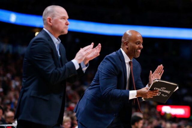 Denver Nuggets assistant coach Wes Unseld Jr. (R) and head coach Michael Malone react after a play in the fourth quarter against the Los Angeles Lakers at the Pepsi Center.