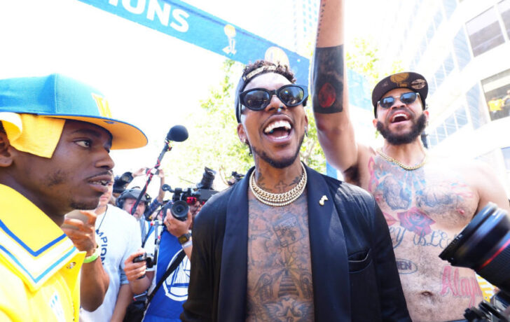 Golden State Warriors guard Nick Young (middle) and center JaVale McGee (right) celebrate during the championship parade in downtown Oakland.