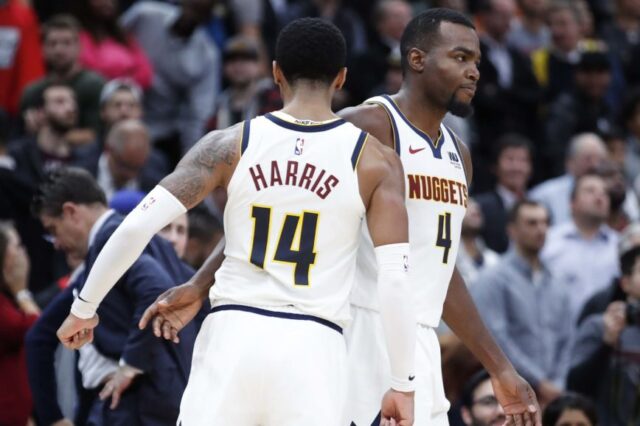 Denver Nuggets forward Paul Millsap (4) is congratulated by guard Gary Harris (14) after scoring game winning points in overtime against the Chicago Bulls at United Center.
