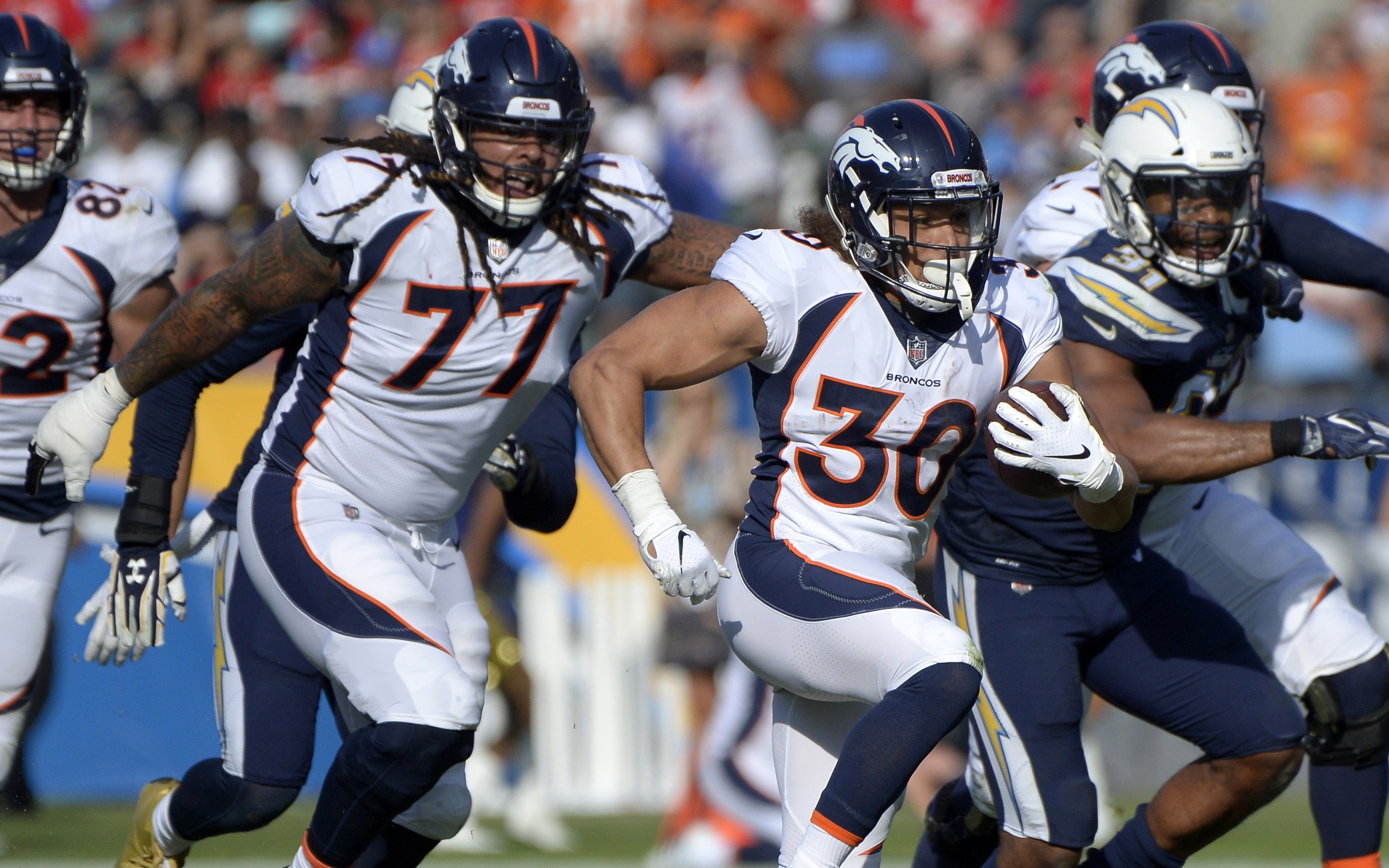 USATSI_11695699 Cropped Phillip Lindsay runs away from defenders. Credit: Jake Roth, USA TODAY Sports.