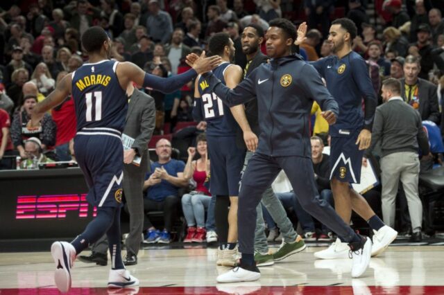 The Denver Nuggets bench congratulates teammates after a game against the Portland Trail Blazers at Moda Center.
