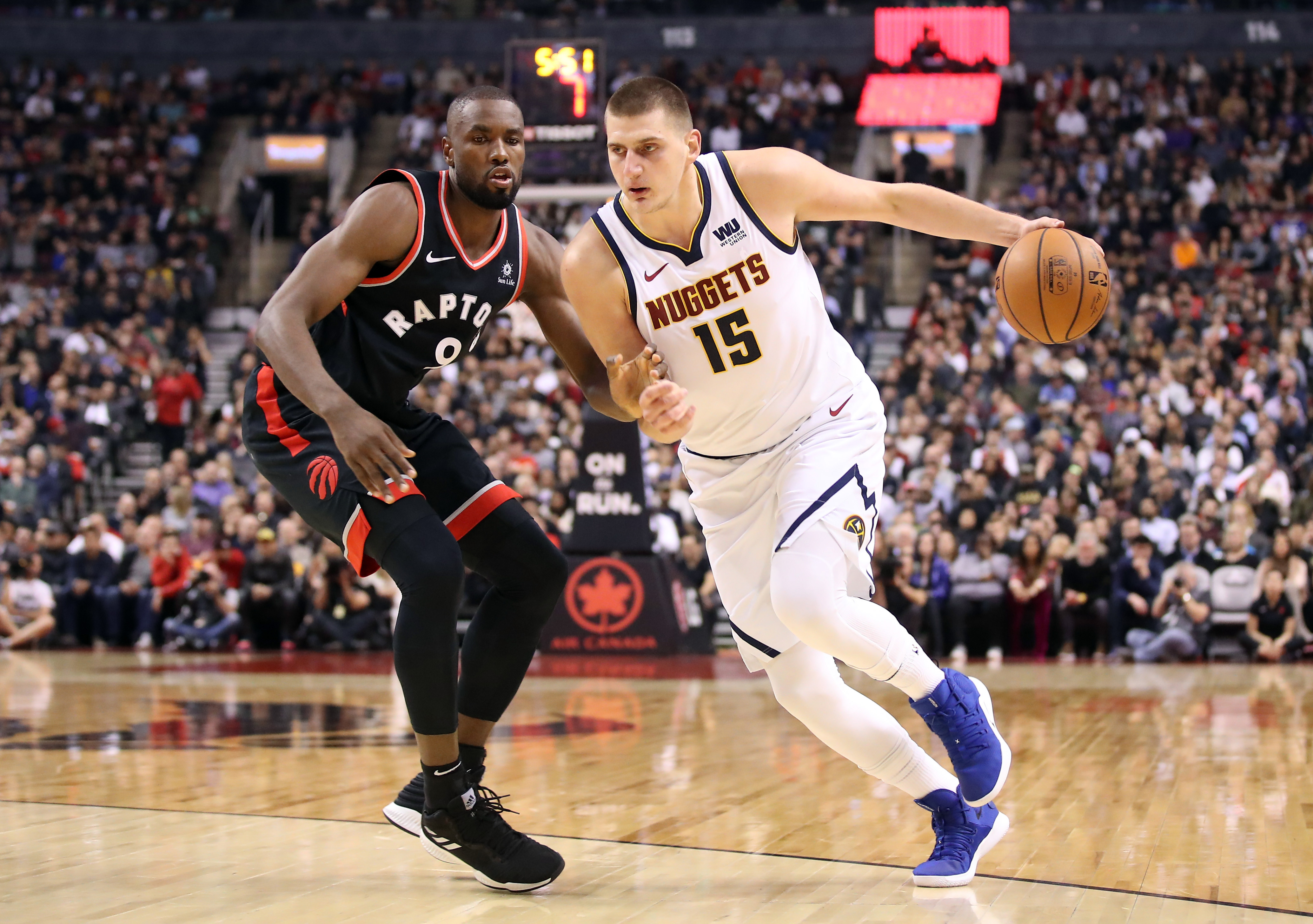 Denver Nuggets center Nikola Jokic drives past Toronto Raptors forward Serge Ibaka in the second quarter at Scotiabank Arena