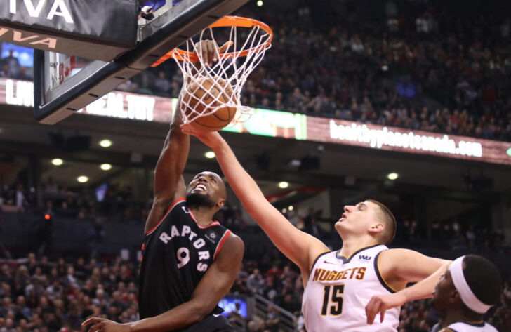 Toronto Raptors forward Serge Ibaka (9) dunks to tie the game in the fourth quarter against Denver Nuggets center Nikola Jokic (15) at Scotiabank Arena. The Nuggets beat the Raptors 106-103.