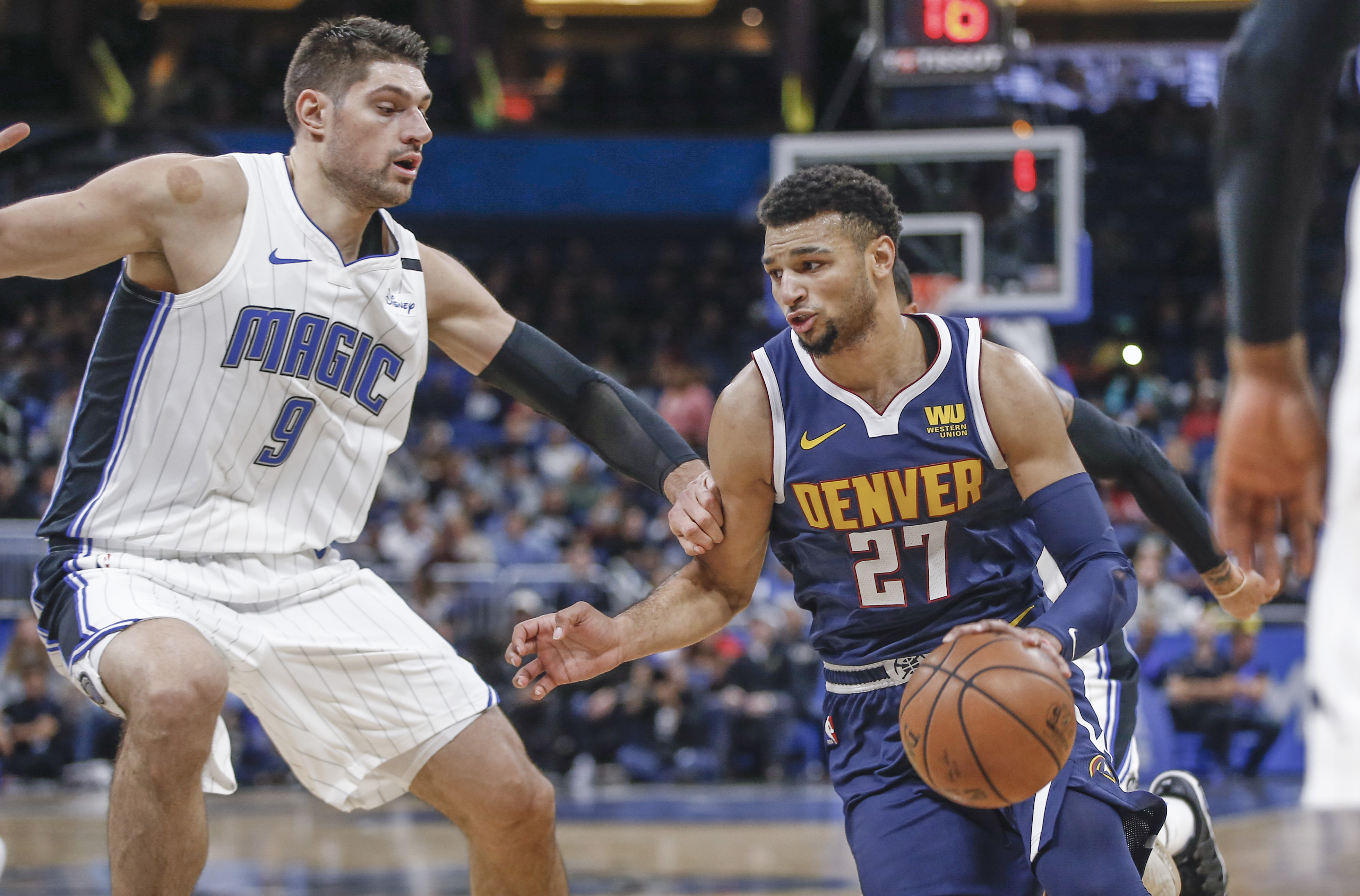 NBA: Denver Nuggets at Orlando Magic Denver Nuggets guard Jamal Murray (27) drives around Orlando Magic center Nikola Vucevic (9) during the first quarter at Amway Center.