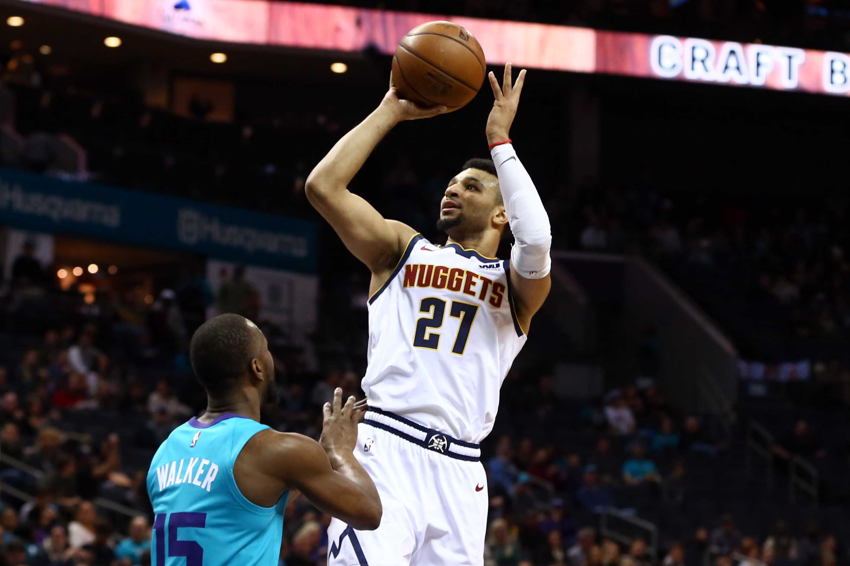 NBA: Denver Nuggets at Charlotte Hornets Denver Nuggets guard Jamal Murray (27) shoots the ball over Charlotte Hornets guard Kemba Walker (15) in the first half at Spectrum Center.