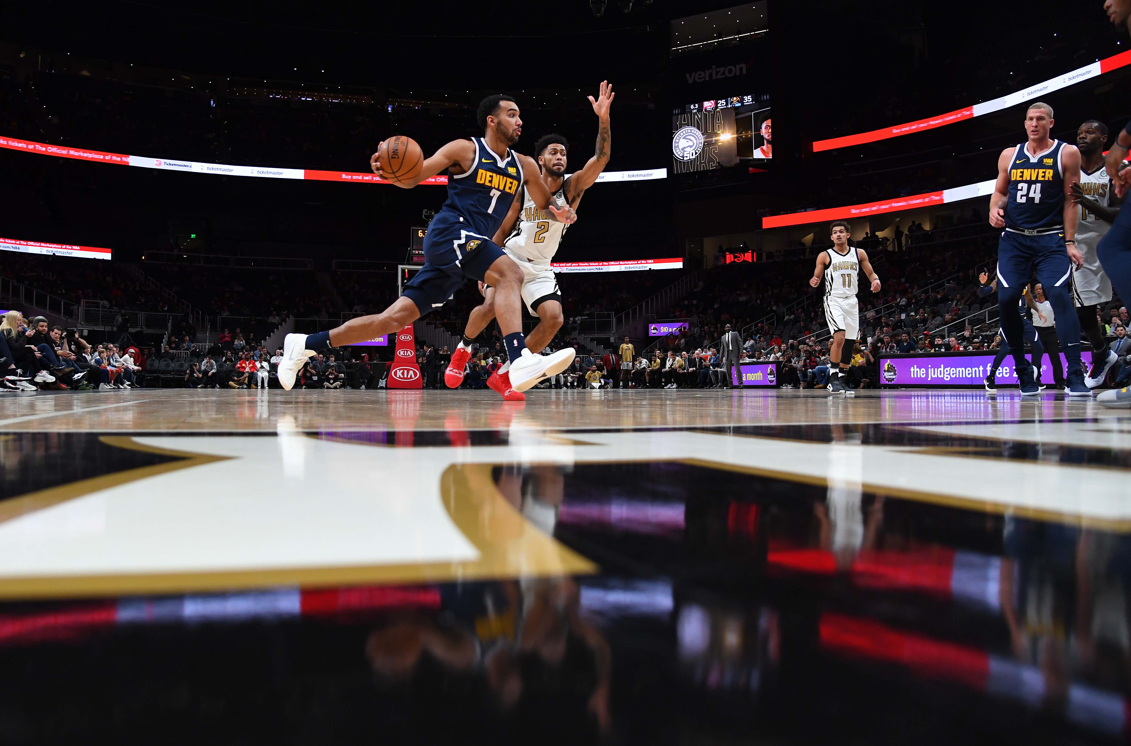 NBA: Denver Nuggets at Atlanta Hawks Denver Nuggets forward Trey Lyles (7) drives to the basket as he is defended by Atlanta Hawks guard Tyler Dorsey (2) during the first half at State Farm Arena.