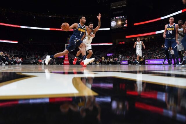 Denver Nuggets forward Trey Lyles (7) drives to the basket as he is defended by Atlanta Hawks guard Tyler Dorsey (2) during the first half at State Farm Arena.