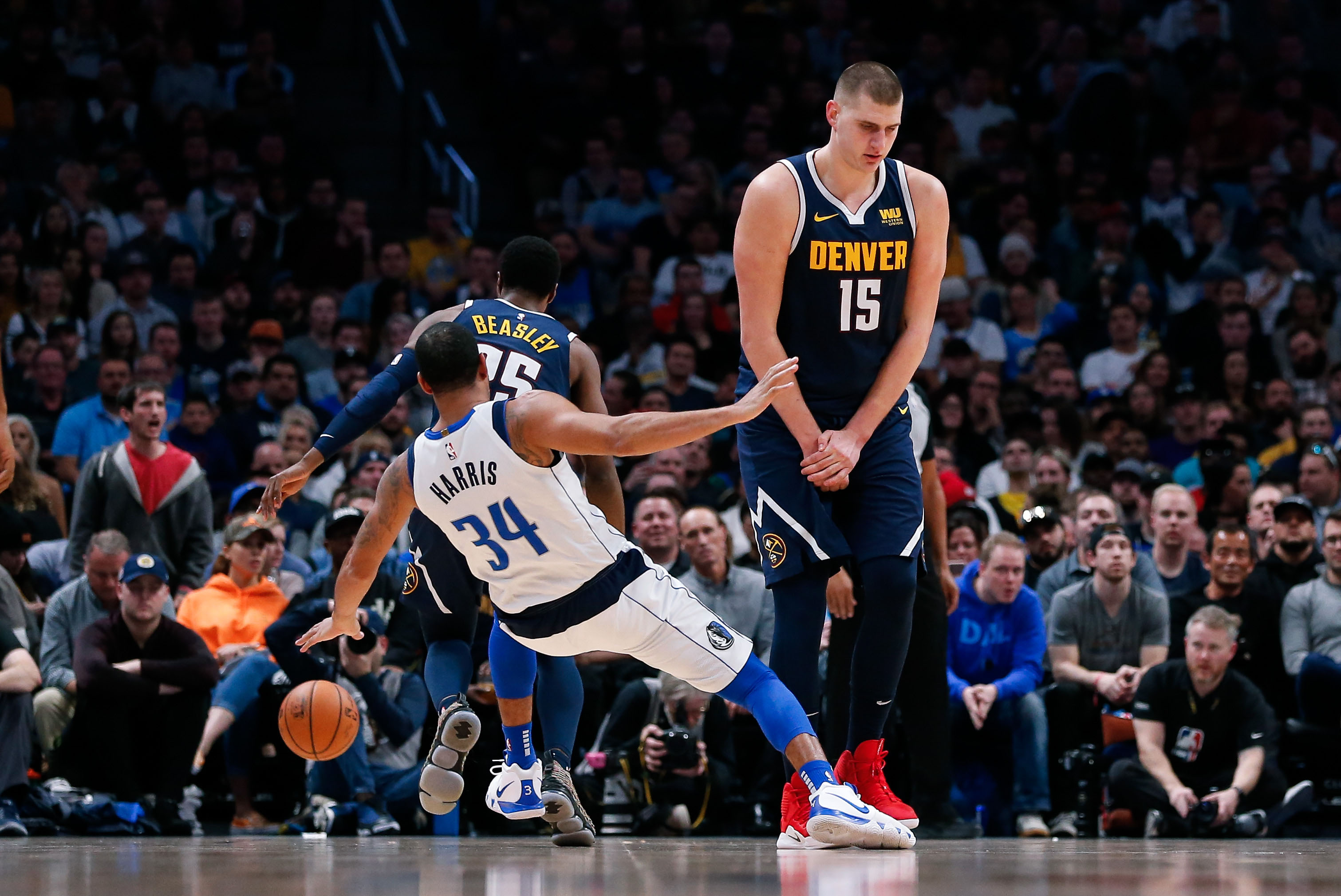 NBA: Dallas Mavericks at Denver Nuggets Dallas Mavericks guard Devin Harris (34) falls to the court as Denver Nuggets center Nikola Jokic (15) screens for guard Malik Beasley (25) in the fourth quarter at the Pepsi Center.