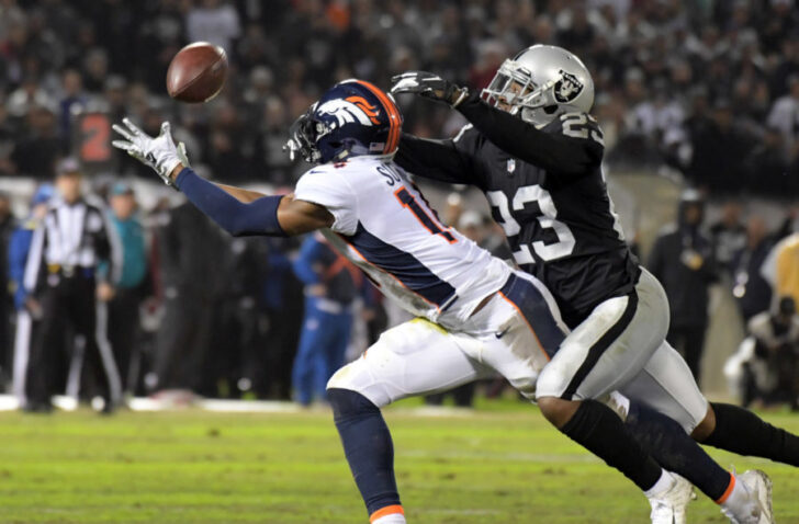 Denver Broncos wide receiver Courtland Sutton (14) catches a pass against Oakland Raiders cornerback Nick Nelson (23) in the first half at Oakland Coliseum.