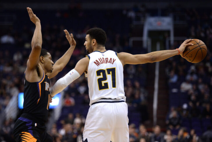 Phoenix Suns guard De'Anthony Melton (14) guards Denver Nuggets guard Jamal Murray (27) during the second half at Talking Stick Resort Arena
