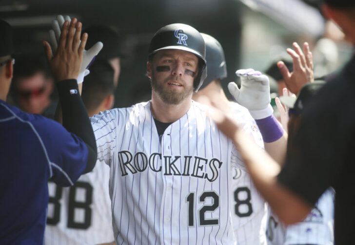 Colorado Rockies first baseman Mark Reynolds (12) celebrates with teammates in the dugout after hitting a two run home run during the sixth inning against the Pittsburgh Pirates at Coors Field.