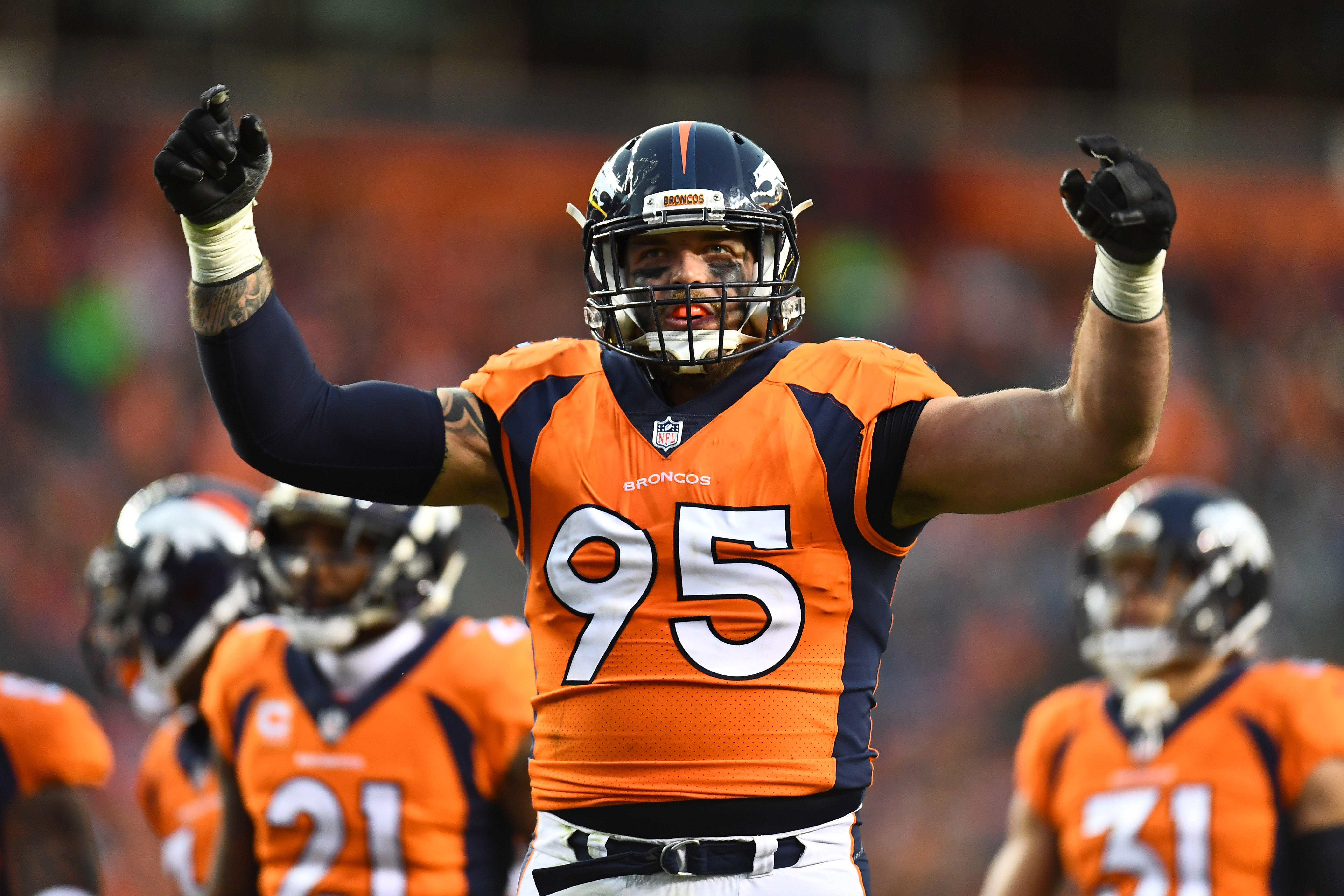 Denver Broncos defensive end Derek Wolfe (95) attempts to rally the crowd in the second half against the Cincinnati Bengals at Sports Authority Field at Mile High.