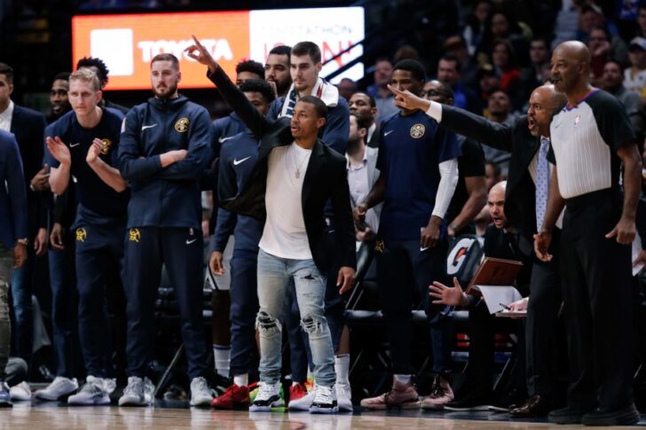 Denver Nuggets guard Isaiah Thomas (center) reacts from the bench with teammates in the fourth quarter against the Toronto Raptors at the Pepsi Center.