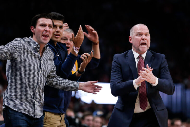 Denver Nuggets head coach Michael Malone (right) and fans react after a call in the second quarter against the New York Knicks at the Pepsi Center.