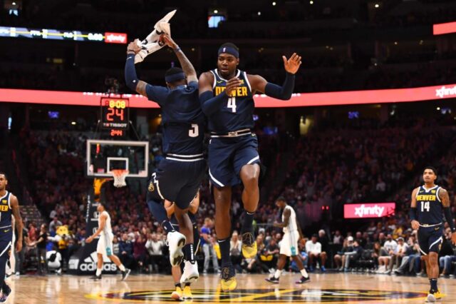 Denver Nuggets forward Paul Millsap (4) celebrates with forward Torrey Craig (3) after a timeout called by the Charlotte Hornets at the Pepsi Center.