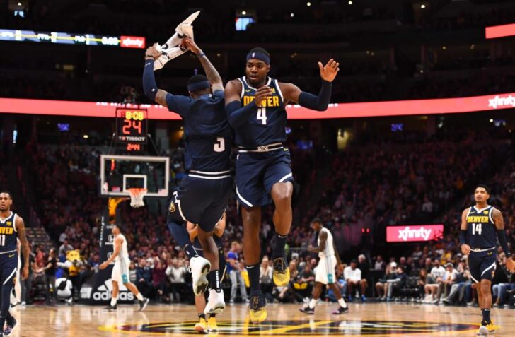 Denver Nuggets forward Paul Millsap (4) celebrates with forward Torrey Craig (3) after a timeout called by the Charlotte Hornets at the Pepsi Center.