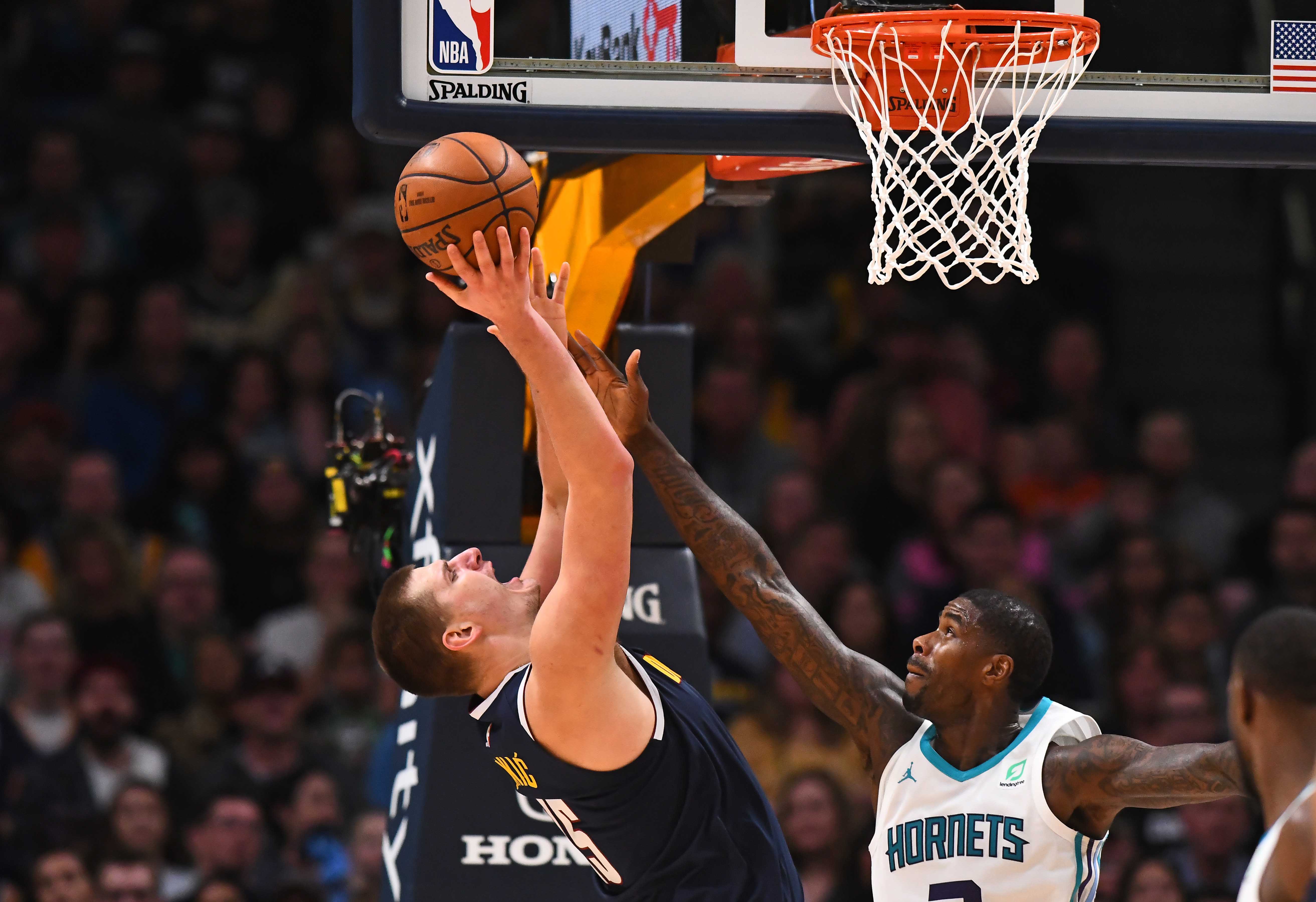 NBA: Charlotte Hornets at Denver Nuggets Charlotte Hornets forward Marvin Williams (2) reaches for the ball over Denver Nuggets center Nikola Jokic (15) in the second half at the Pepsi Center.