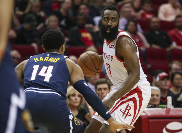 Houston Rockets guard James Harden (13) dribbles the ball against Denver Nuggets guard Gary Harris (14) during the first quarter at Toyota Center.