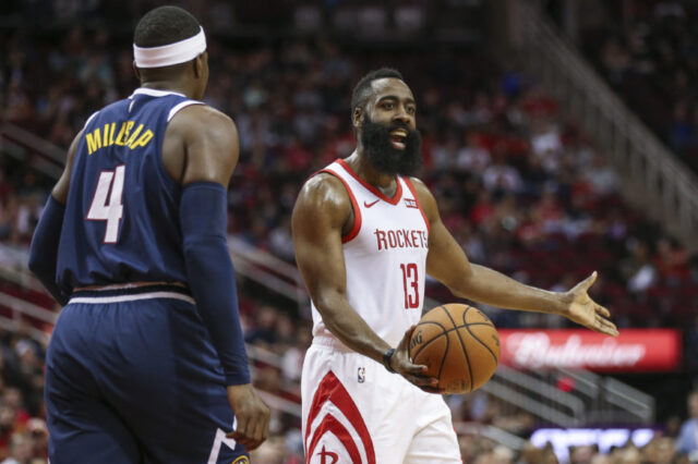 Houston Rockets guard James Harden (13) reacts while Denver Nuggets forward Paul Millsap (4) looks on after a play during the first quarter at Toyota Center.