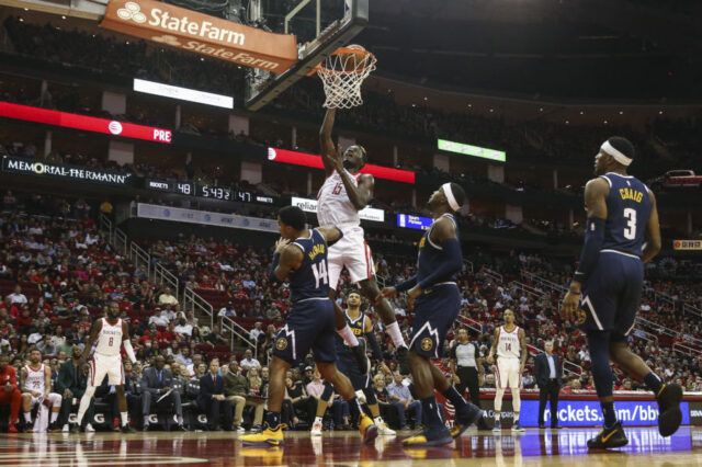 Houston Rockets center Clint Capela (15) attempts to score a basket against Denver Nuggets guard Gary Harris (14) during the second quarter at Toyota Center.