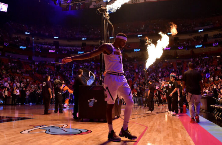 Denver Nuggets forward Torrey Craig (3) stretches as flames are seen while members of the Miami Heat are introduced at American Airlines Arena.