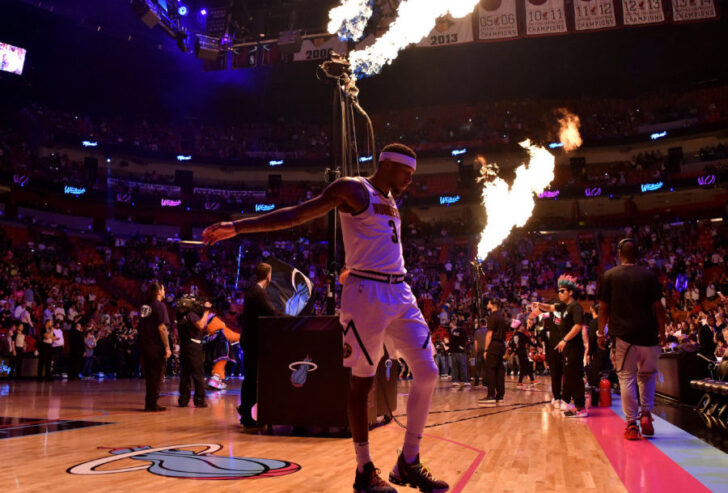 Denver Nuggets forward Torrey Craig (3) stretches as flames are seen while members of the Miami Heat are introduced at American Airlines Arena.