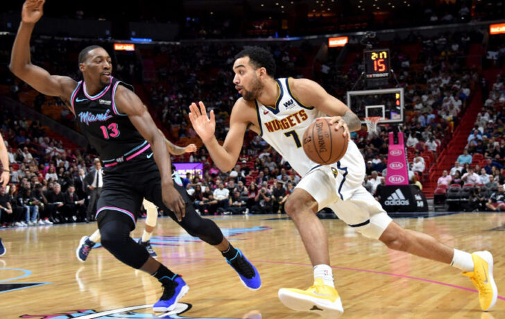 iami Heat center Bam Adebayo (13) pressures Denver Nuggets forward Trey Lyles (7) during the first half at American Airlines Arena.