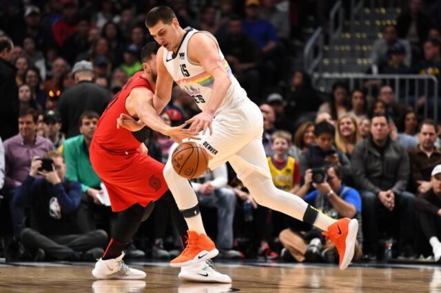 Portland Trail Blazers center Jusuf Nurkic (27) reaches in on Denver Nuggets center Nikola Jokic (15) in the first quarter at the Pepsi Center.