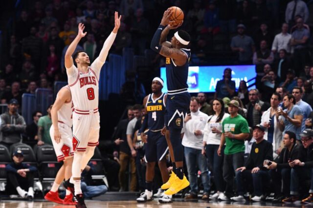 Denver, CO, USA; Denver Nuggets forward Torrey Craig (3) attempts a three point basket over Chicago Bulls guard Zach LaVine (8) in the first quarter of the game at the Pepsi Center.