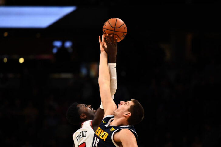 Chicago Bulls forward Bobby Portis (5) and Denver Nuggets center Nikola Jokic (15) reach during tipoff n the first quarter of the game at the Pepsi Center.