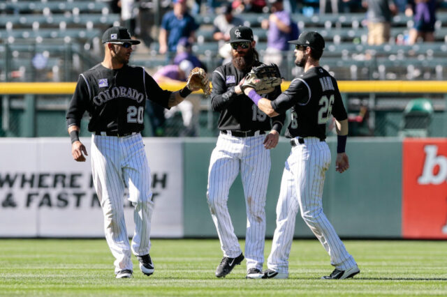 Colorado Rockies left fielder Ian Desmond (20) and center fielder Charlie Blackmon (19) and right fielder David Dahl (26) celebrate after the game against the San Diego Padres at Coors Field. Mandatory Credit: Isaia