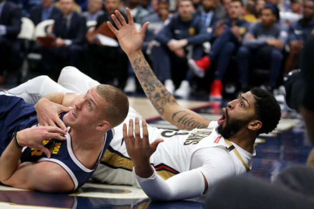 Denver Nuggets forward Mason Plumlee (24) and New Orleans Pelicans forward Anthony Davis (23) wait for a foul call in the second half at the Smoothie King Center. Davis was called for the foul.