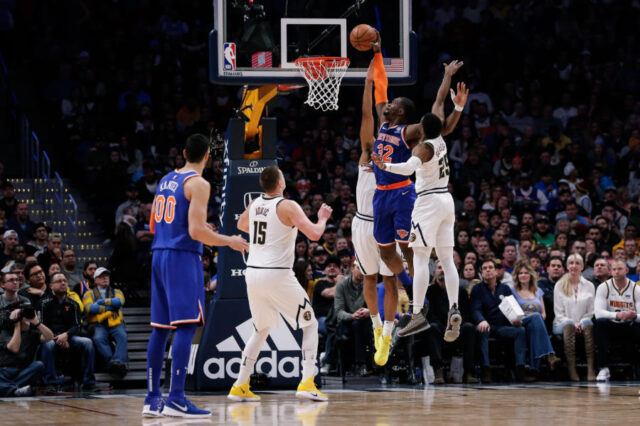 New York Knicks forward Noah Vonleh (32) dunks the ball against Denver Nuggets forward Trey Lyles (7) and guard Malik Beasley (25) as center Nikola Jokic (15) and Knicks center Enes Kanter (00) look on in the second quarter at the Pepsi Center.