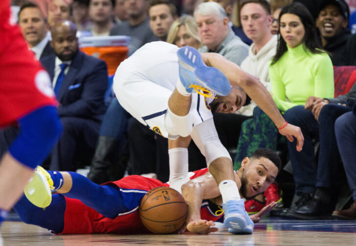 Philadelphia 76ers guard Ben Simmons (25) battles for the ball with Denver Nuggets guard Jamal Murray (27) during the first quarter at Wells Fargo Center.