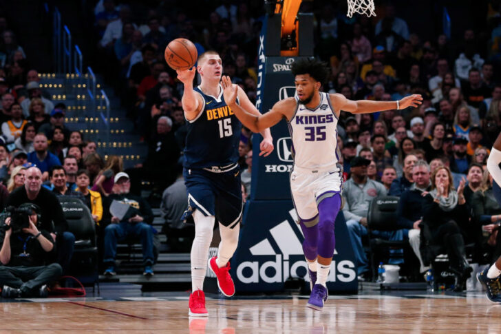 Denver Nuggets center Nikola Jokic (15) passes the ball as Sacramento Kings forward Marvin Bagley III (35) defends in the second quarter at the Pepsi Center.