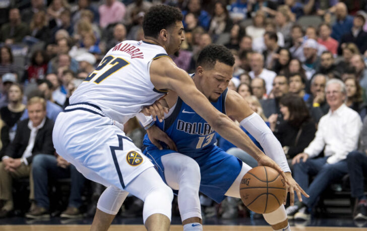 Denver Nuggets guard Jamal Murray (27) and Dallas Mavericks guard Jalen Brunson (13) fight for the loose ball during second quarter at the American Airlines Center.