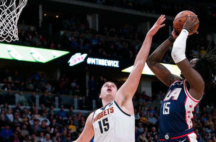 Los Angeles Clippers forward Johnathan Motley (15) shoots against Denver Nuggets center Nikola Jokic (15) in the fourth quarter at the Pepsi Center.