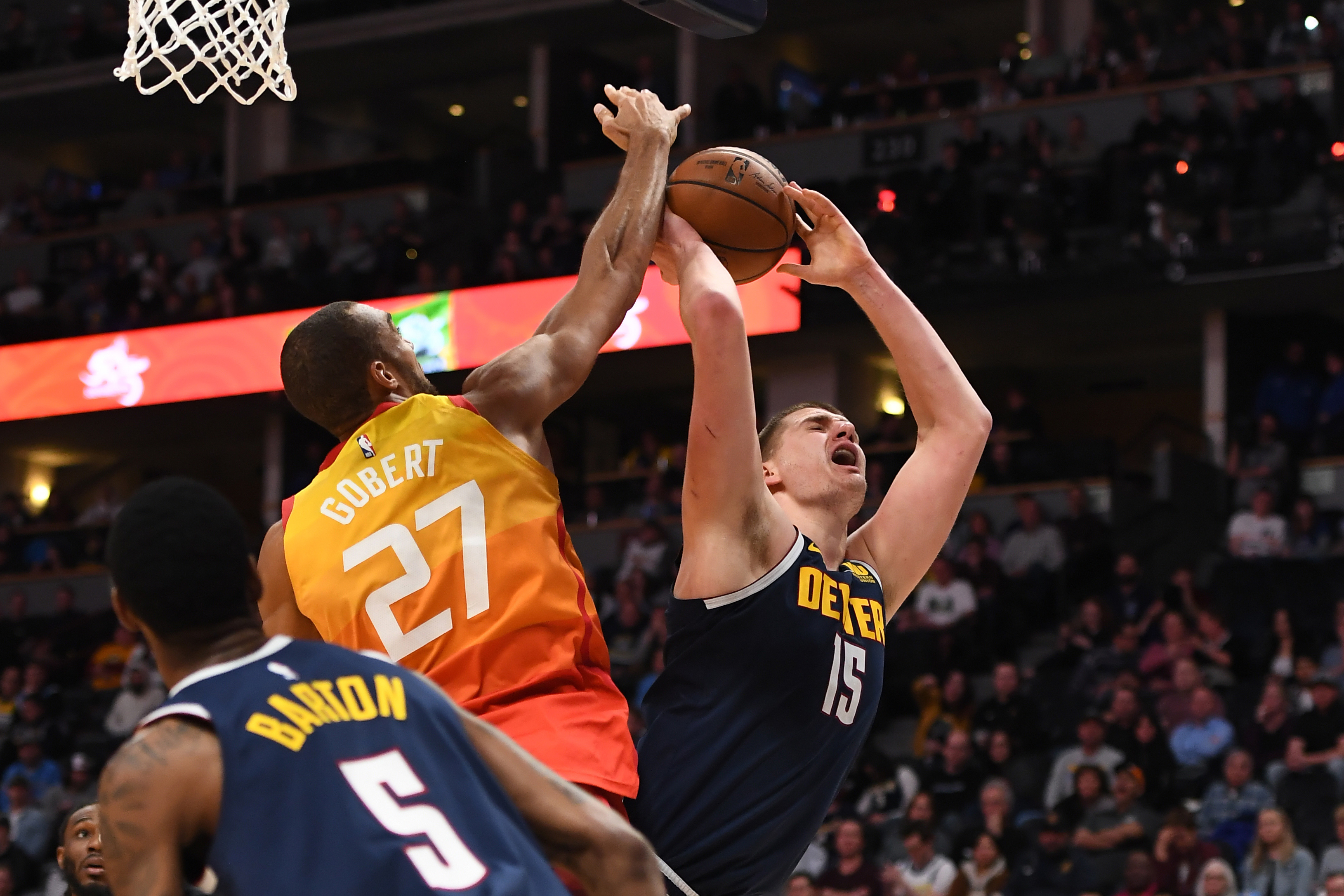 NBA: Utah Jazz at Denver Nuggets Denver Nuggets center Nikola Jokic (15) attempts a shot past Utah Jazz center Rudy Gobert (27) in the second half at the Pepsi Center.
