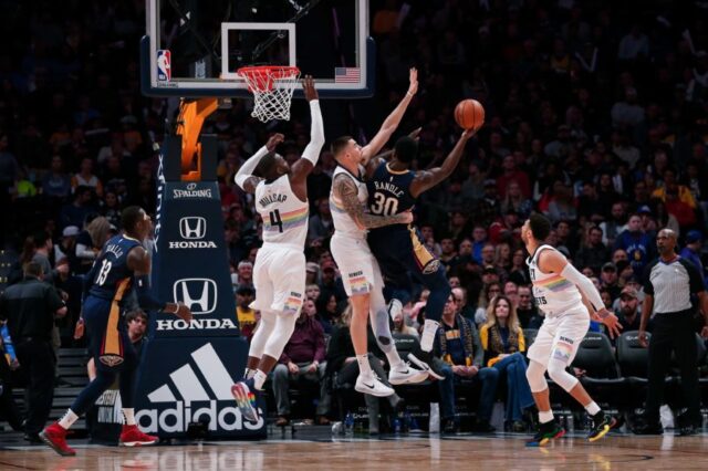 Denver Nuggets forward Juancho Hernangomez (41) and forward Paul Millsap (4) defend as New Orleans Pelicans center Julius Randle (30) drives to the net as guard Jamal Murray (27) looks on in the second quarter at the Pepsi Center.