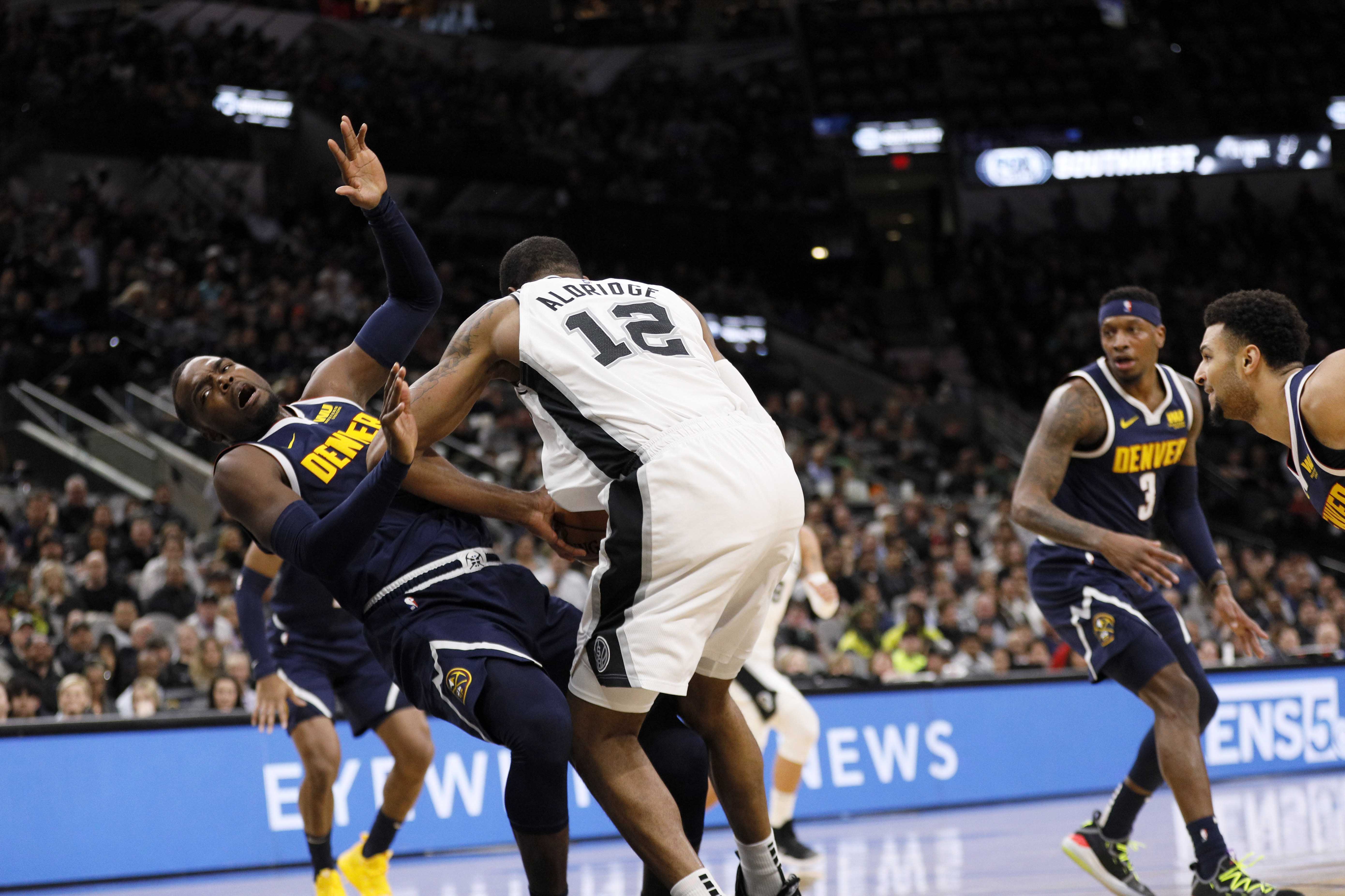 NBA: Denver Nuggets at San Antonio Spurs Denver Nuggets power forward Paul Millsap (left) draws a charge from San Antonio Spurs power forward LaMarcus Aldridge (12) during the first half at AT&T Center.