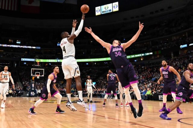Denver Nuggets forward Paul Millsap (4) shoots over Minnesota Timberwolves forward Dario Saric (36) in the first quarter at the Pepsi Center.