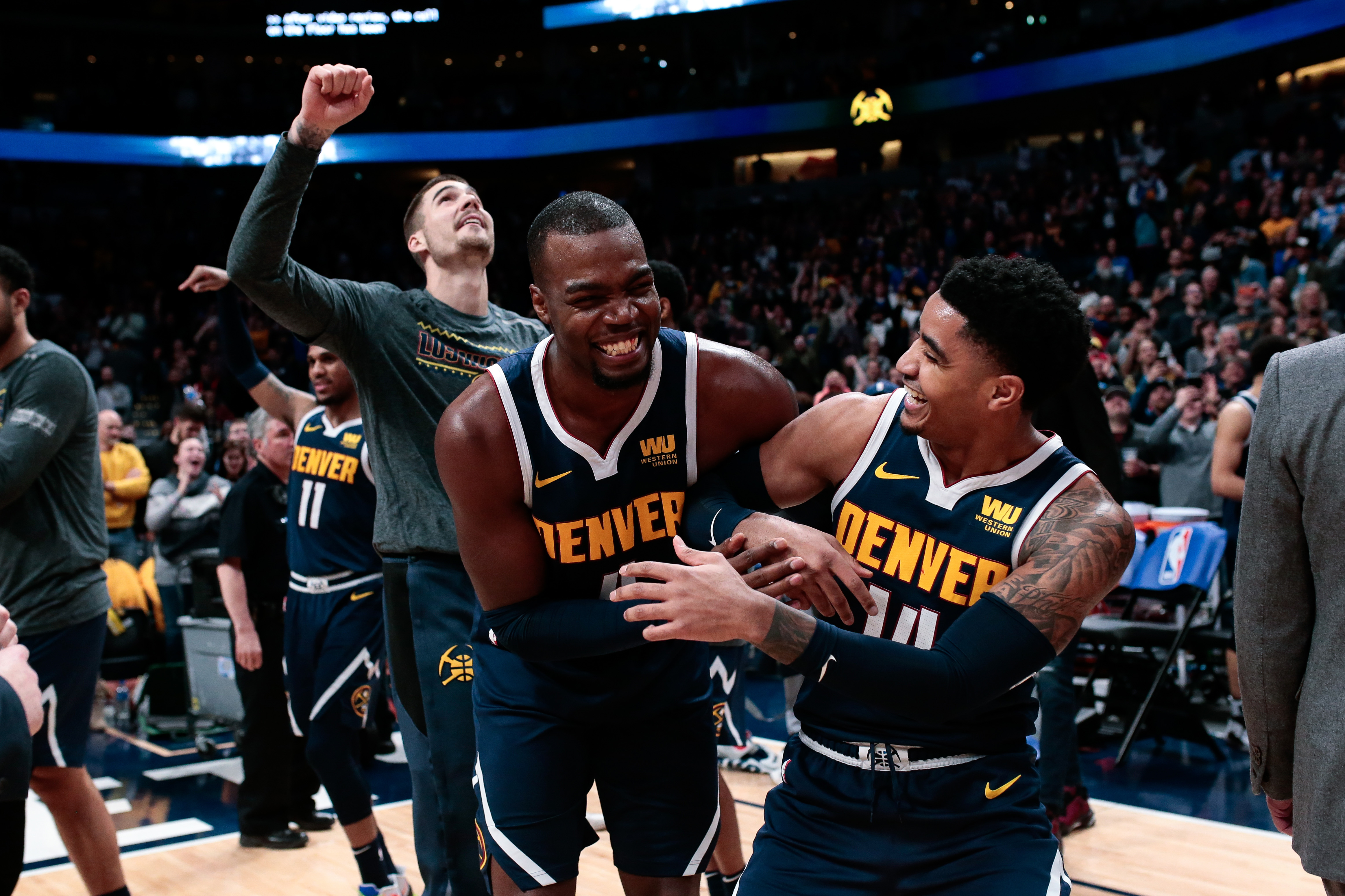 Denver Nuggets forward Paul Millsap (4) and guard Gary Harris (14) react after the game against the Dallas Mavericks at the Pepsi Center.