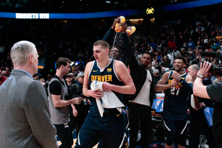Denver Nuggets center Nikola Jokic (15) gets showered with water after the game against the Dallas Mavericks at the Pepsi Center.