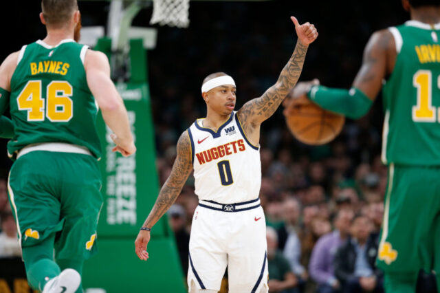 Denver Nuggets point guard Isaiah Thomas (0) signals to the bench during the first half against the Boston Celtics at TD Garden.