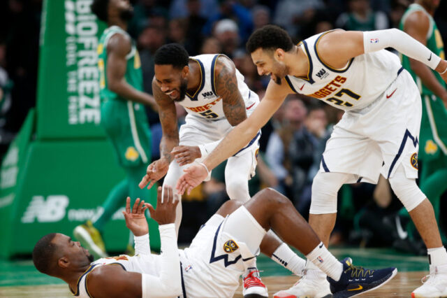 Denver Nuggets guard Will Barton (5) and guard Jamal Murray (27) celebrate with center Paul Millsap (4) during the second half against the Boston Celtics at TD Garden.